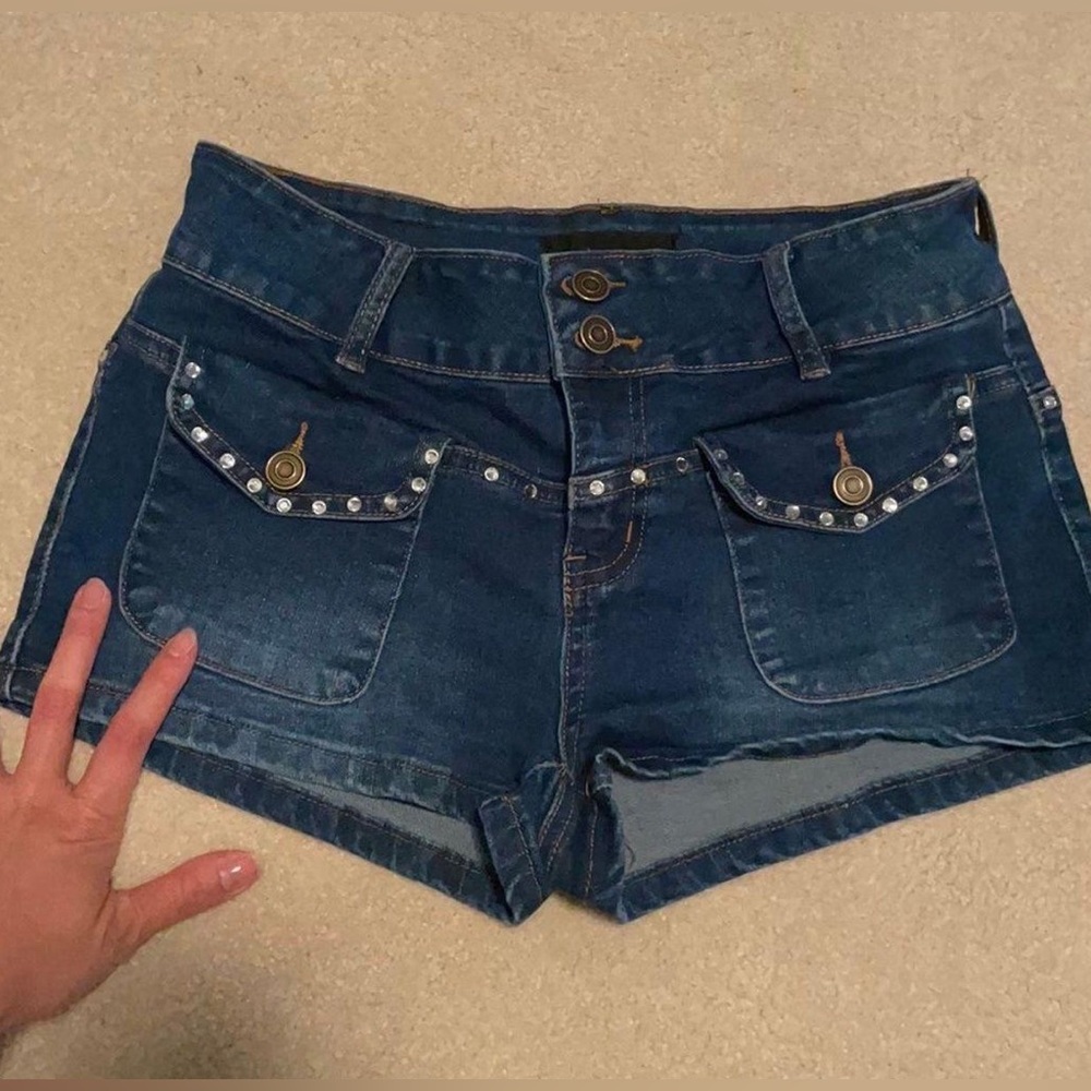 Fashion Nova medium-wash denim shorts with rhinestone detailing.